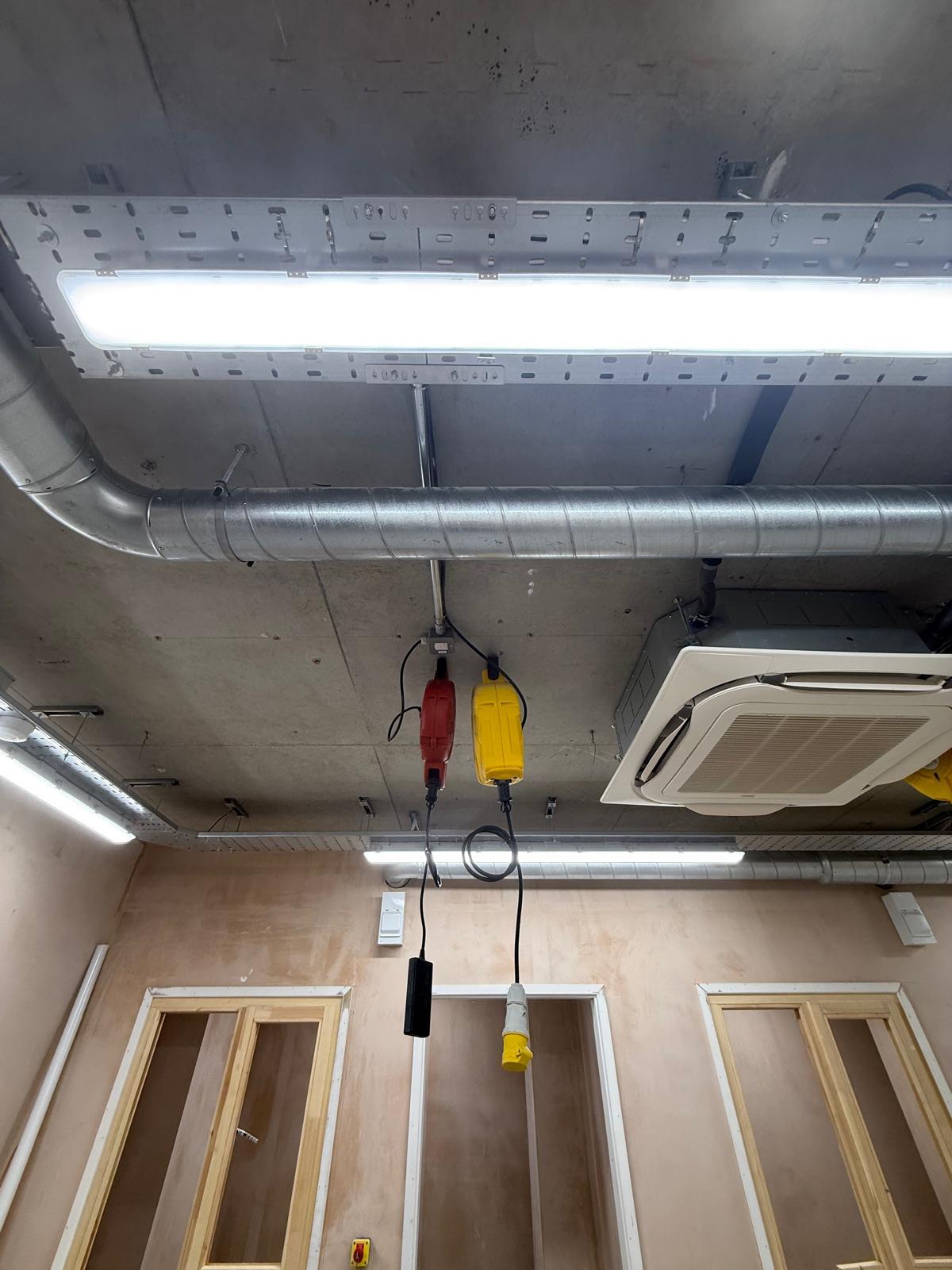 Suspended commercial lighting fitted to cable tray